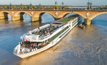 a river ship cruising down a river