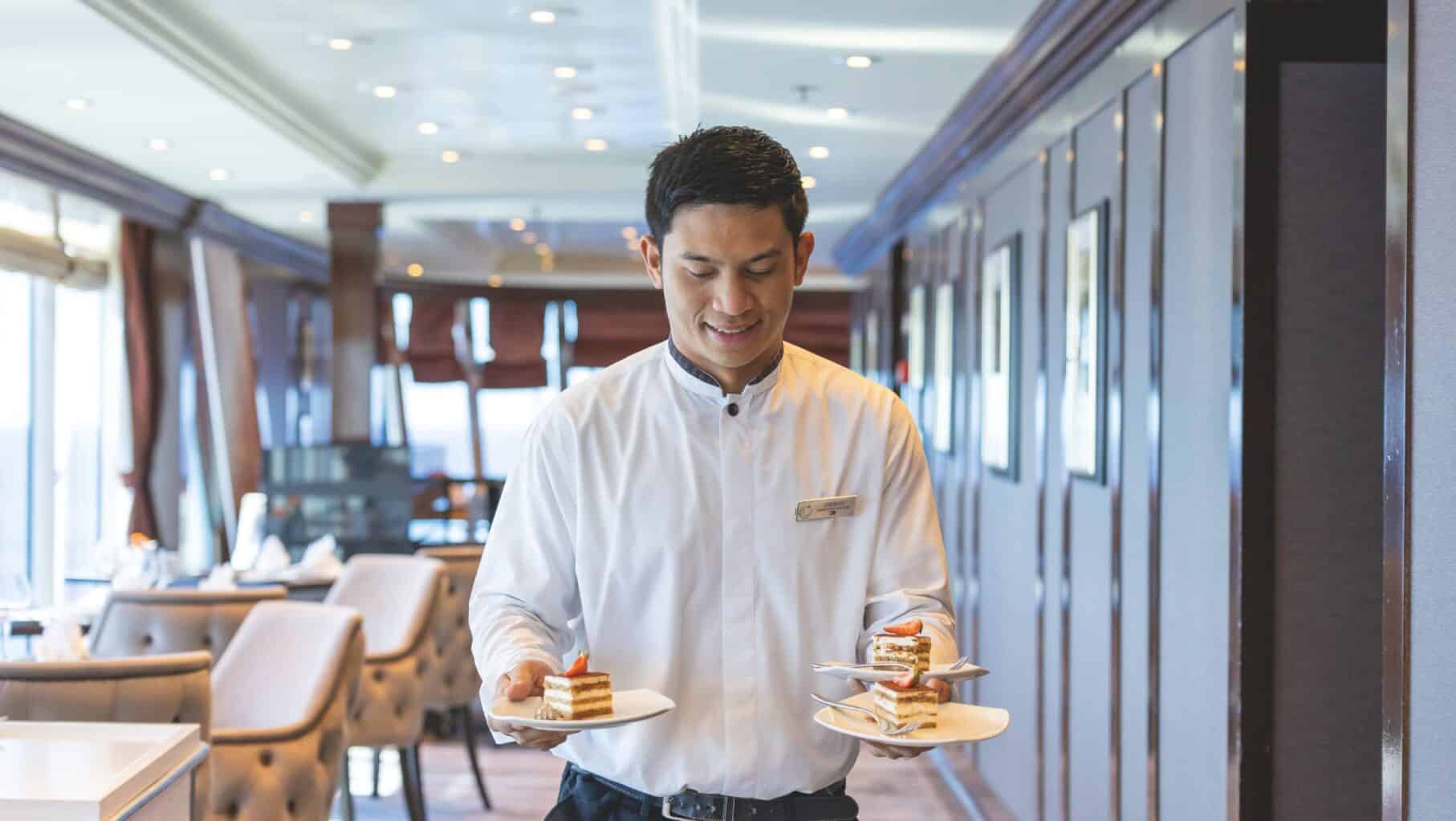 waiter carrying tiramisu 
