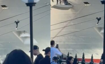Man trying to climb Carnival Adventure