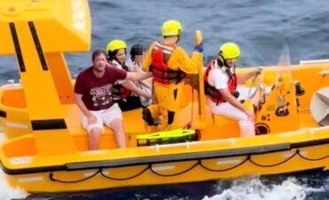 The father and daughter getting rescued after falling off on the Disney Dream