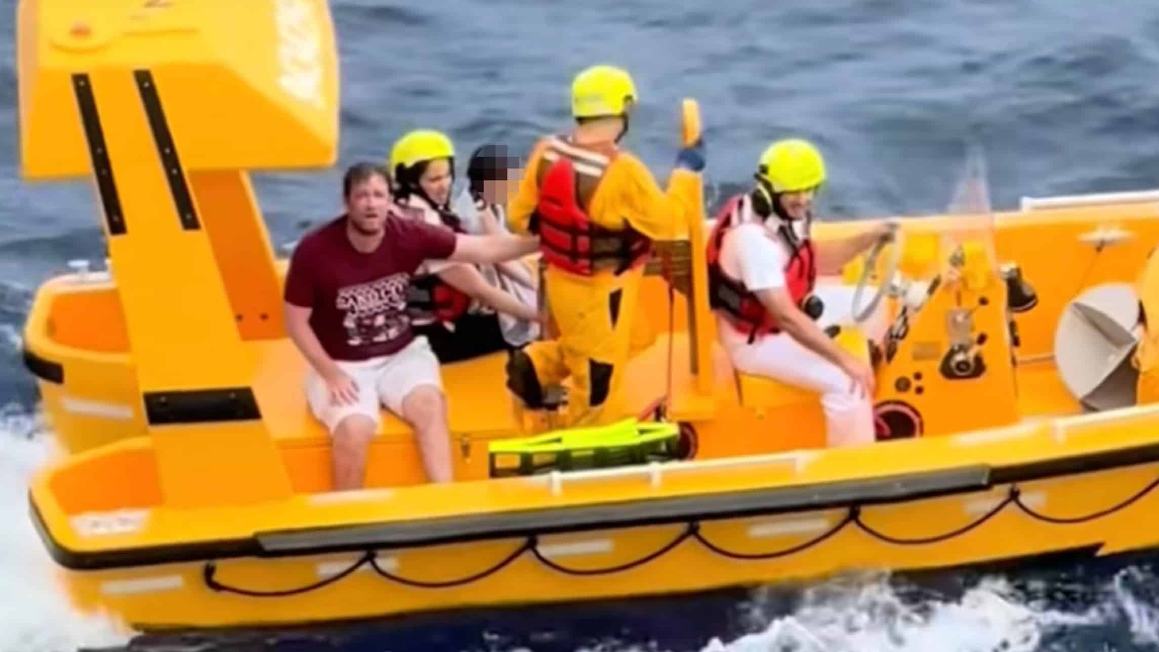 The father and daughter getting rescued after falling off on the Disney Dream
