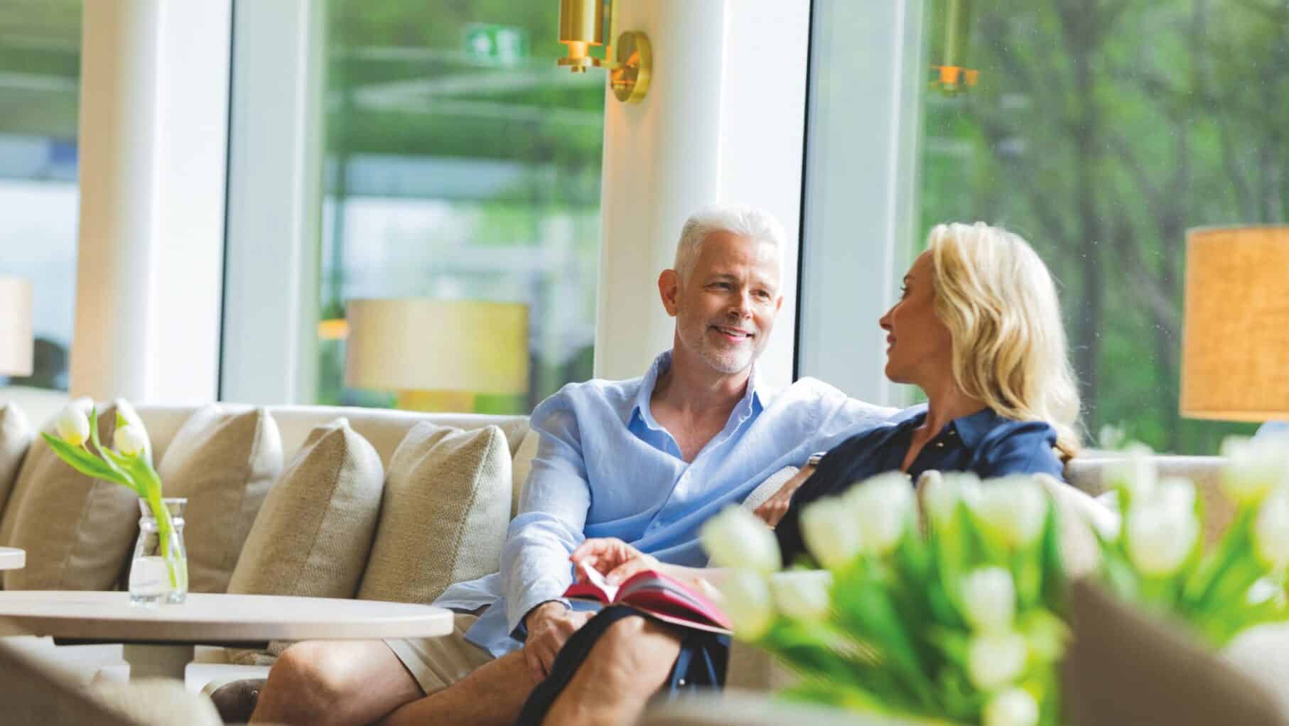Couple relaxing Salon Lounge on the APT Solara
