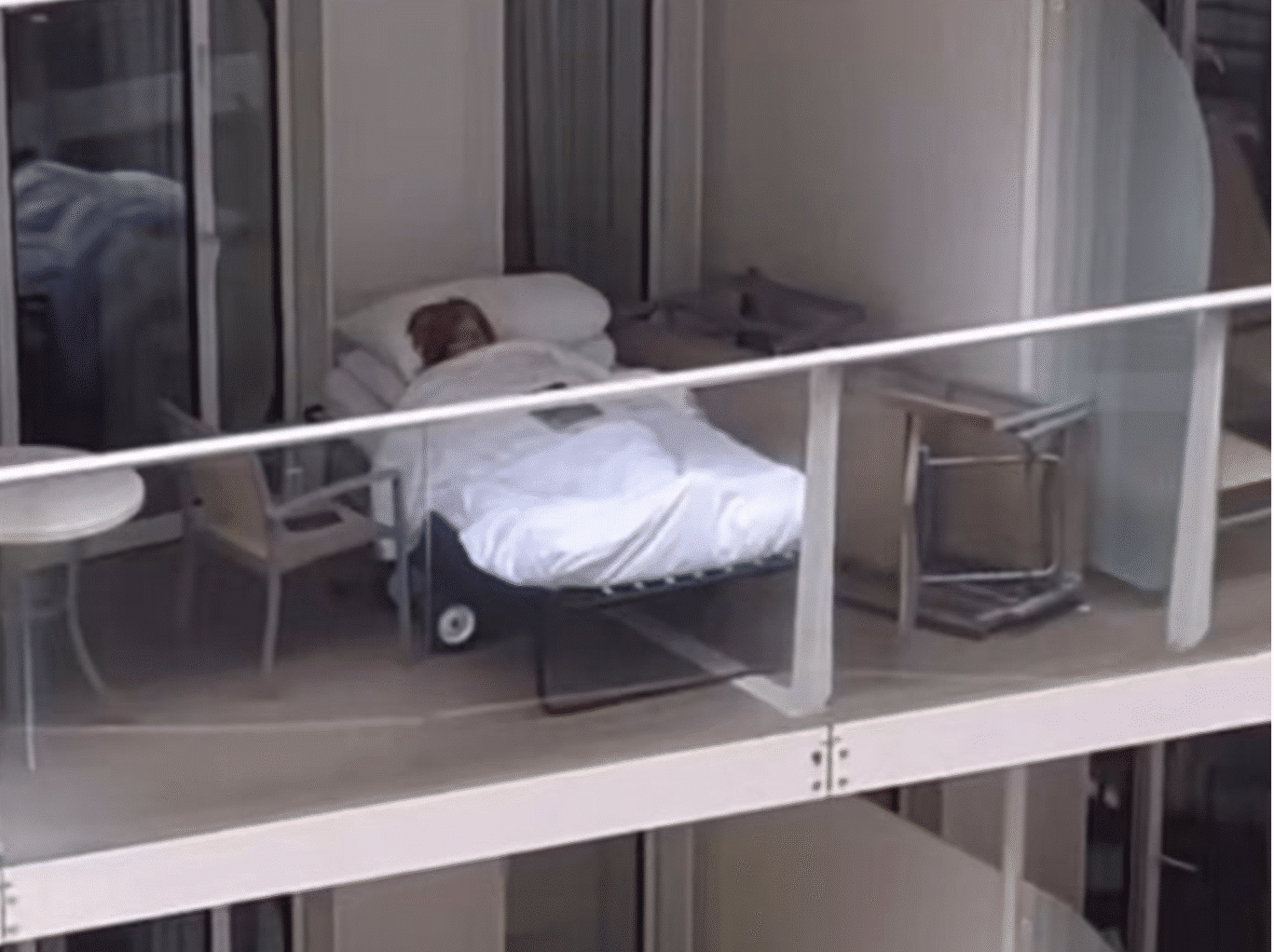 Woman sleeping on cruise ship balcony