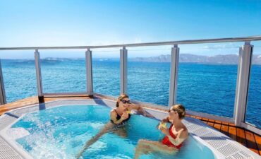Two woman relax at a spa on an NCL ship