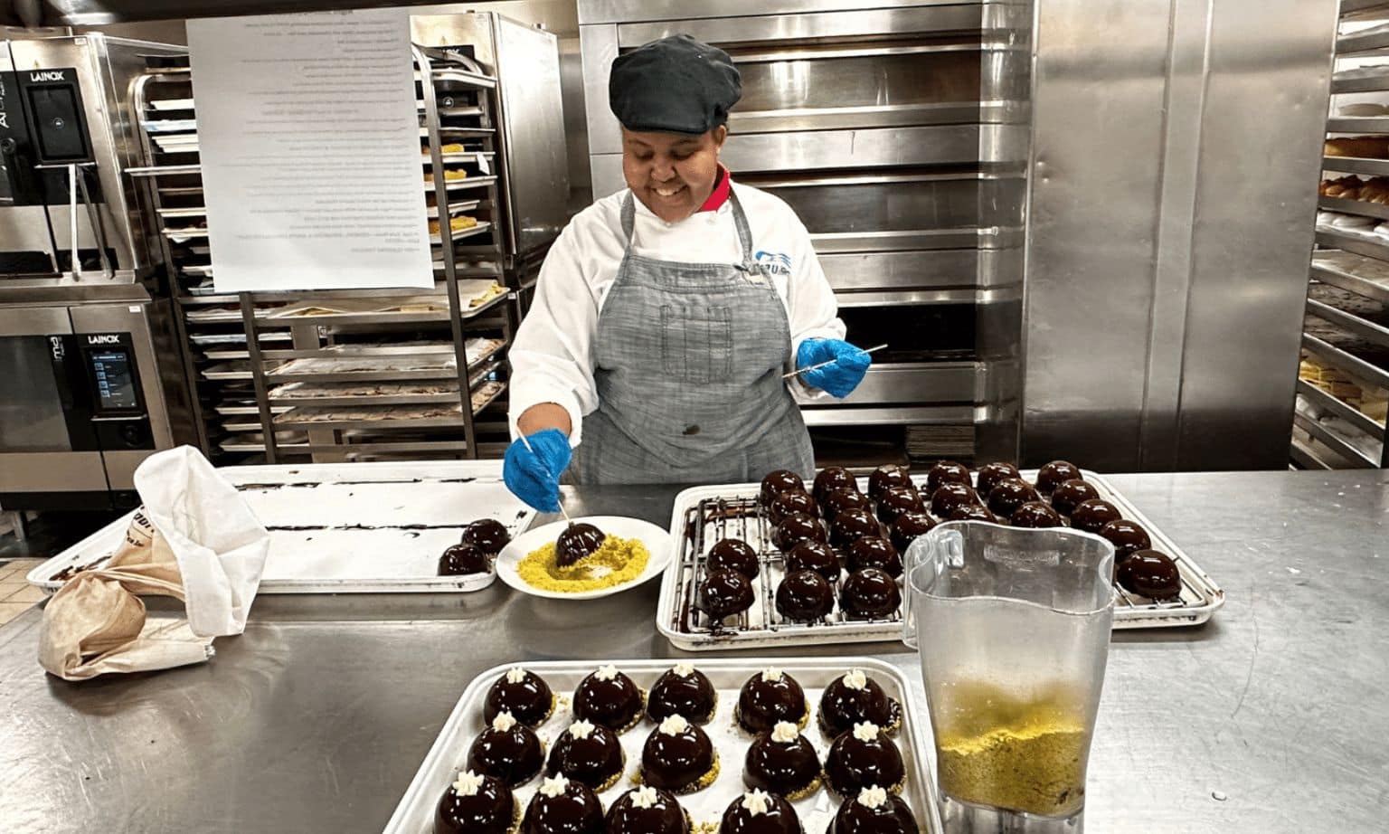 One of the chefs on the Discovery Princess making chocolate dome desserts