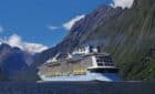 Cruise ship in stunning mountain landscape.
