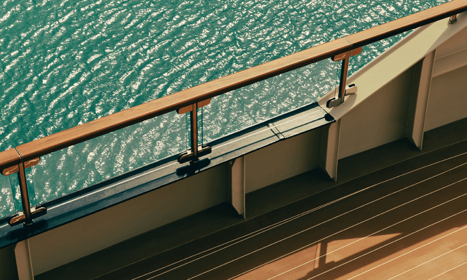 The wooden deck and railing of a luxury yacht