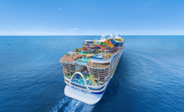 An artists rendering of a very large cruise ship with multi-coloured water slides