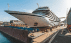 A large cruise ship sits in a building dock