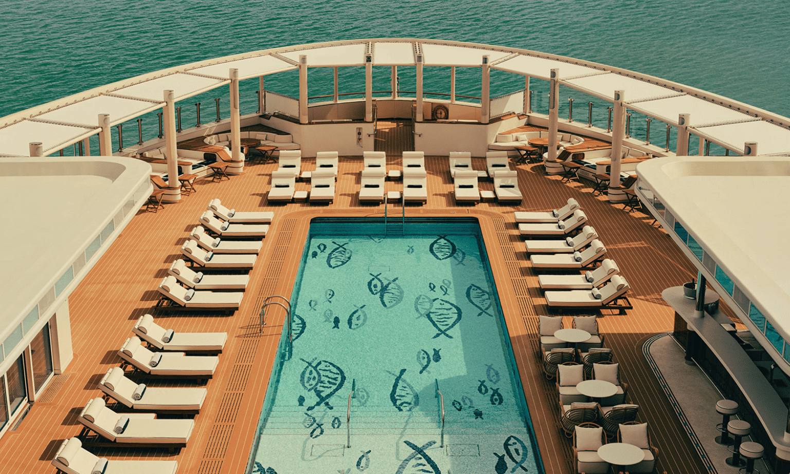 A pool surrounded by lounges on the luxury yacht Four Seasons 1