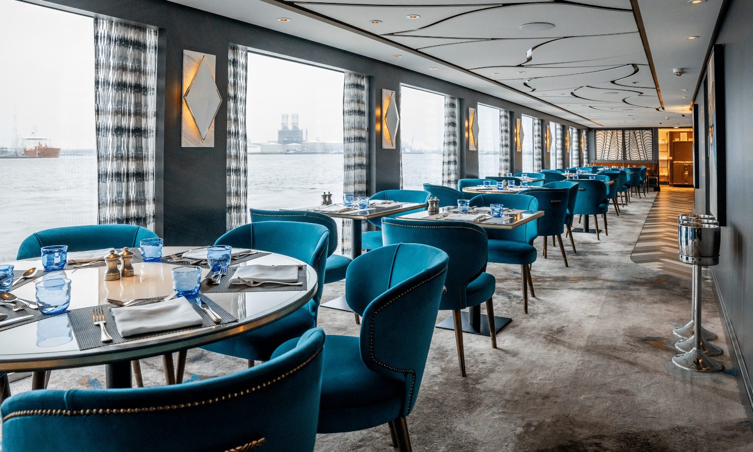 Elegant onboard restaurant with blue upholstered seating