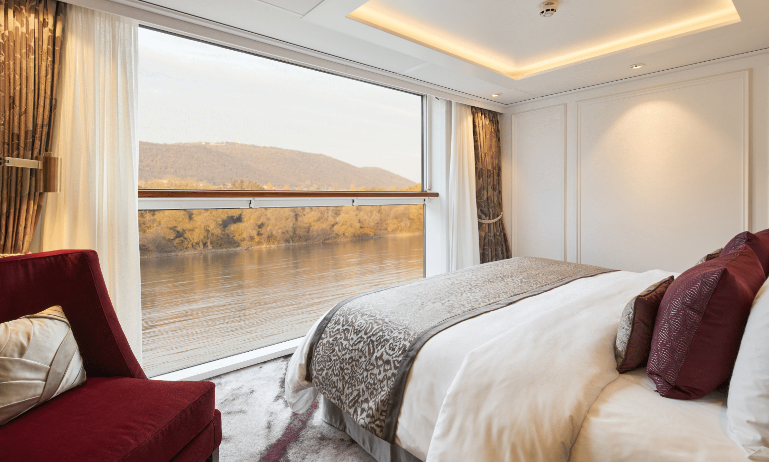 Luxury river cruise suite with a king-size bed