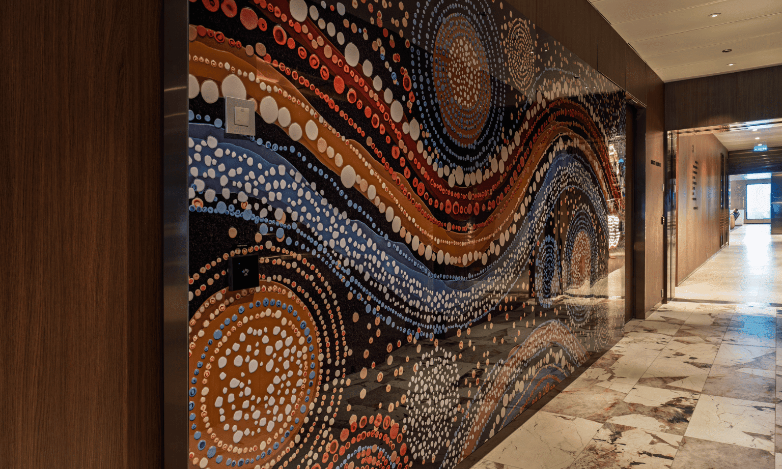 A large indigenous artwork in the hallway of a cruise ship
