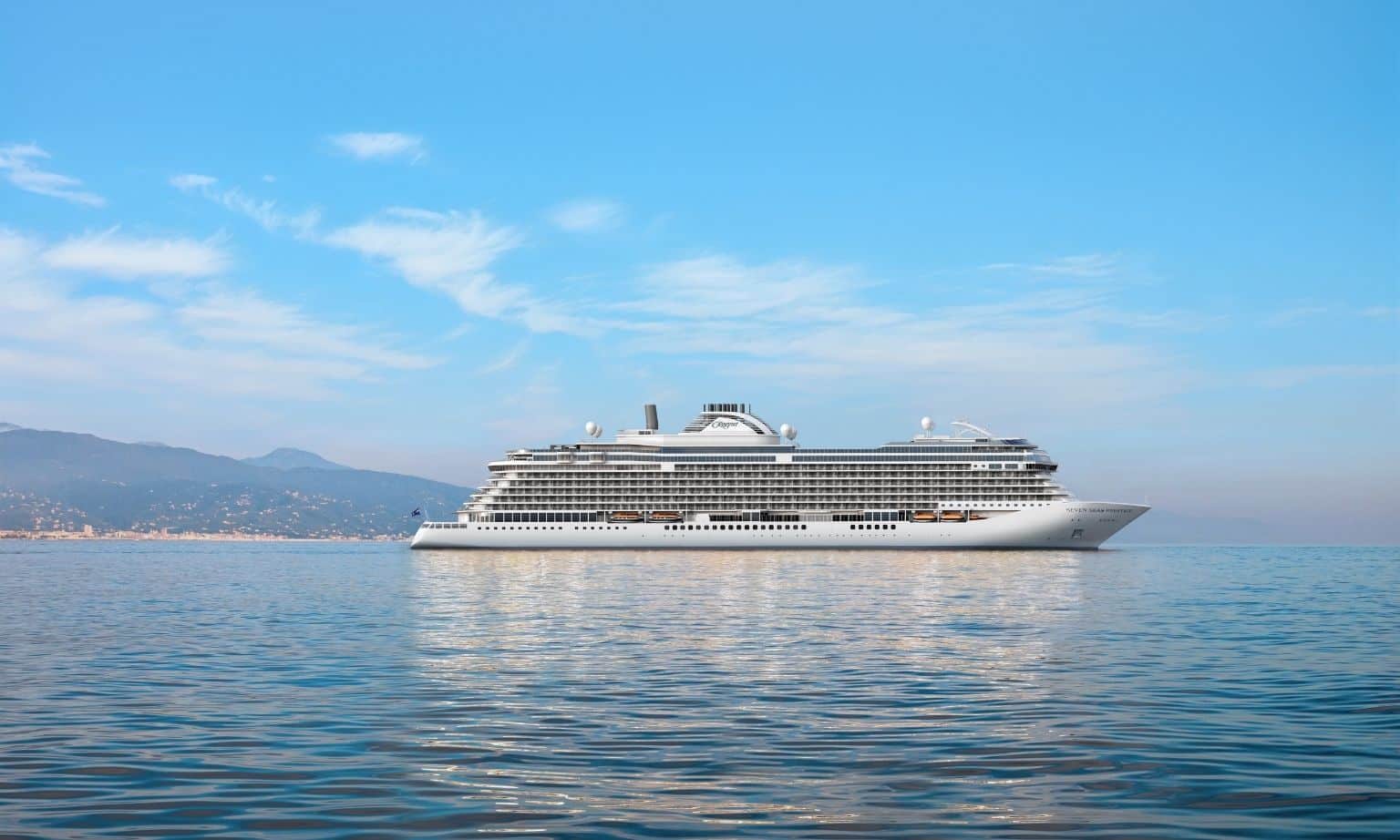 A large white cruise ship on the open water