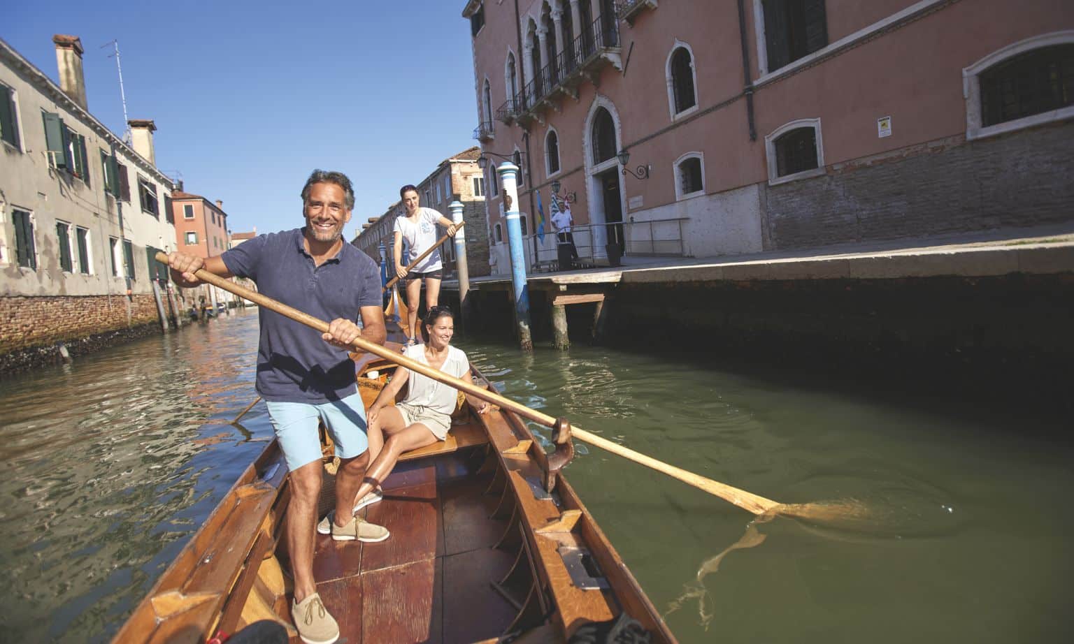 A group of friends travelling in a Gondola in Venice