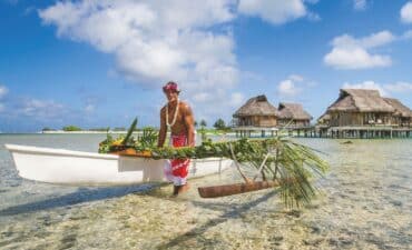 A man in Tahiti with a canoe