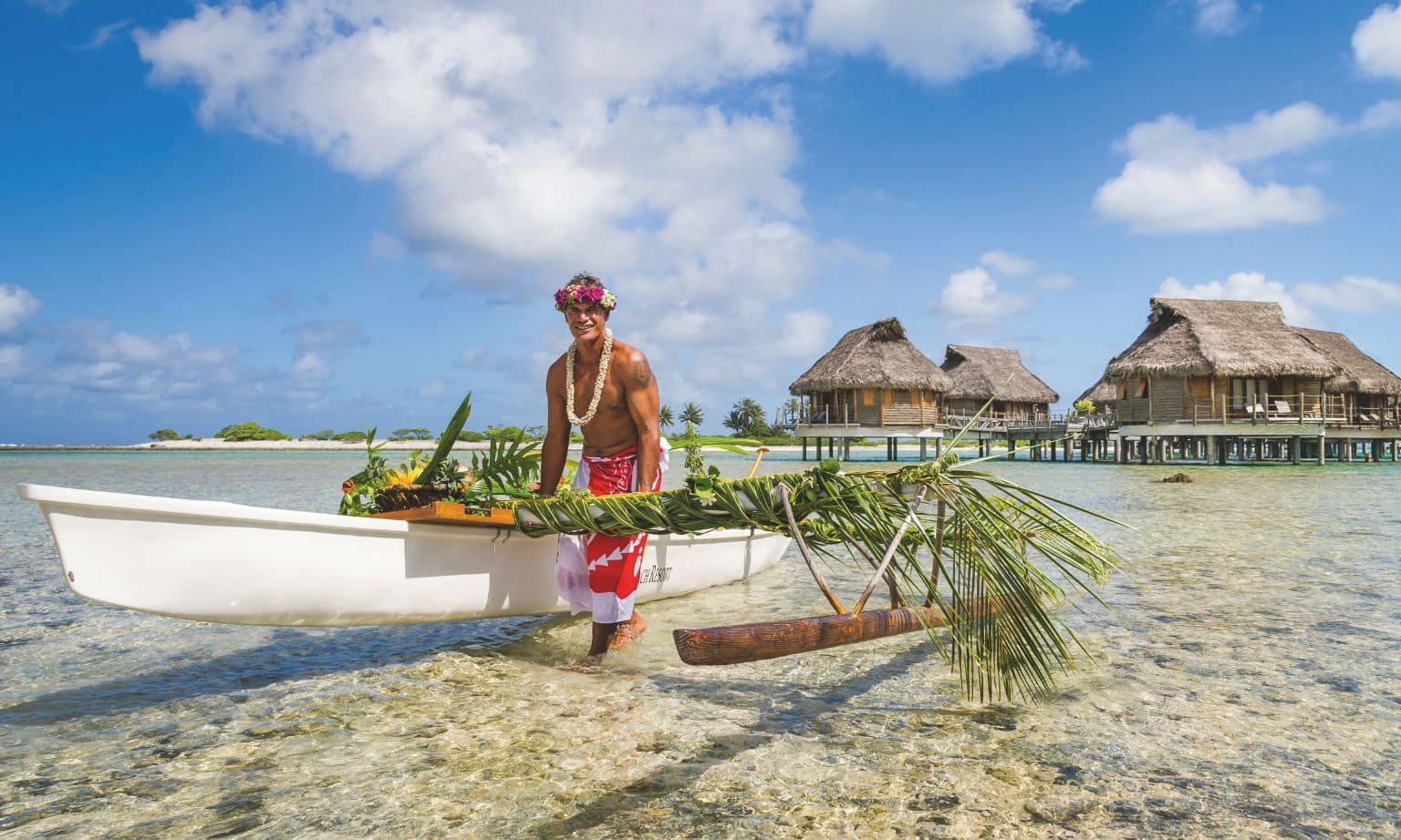 A man in Tahiti with a canoe