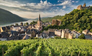 Scenic village with vineyards and river.